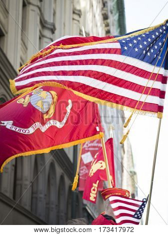 NEW YORK - 11 NOV 2016: American Flag and flag of US Marine Corps, USMC carried by personel marching in Americas Parade up 5th Avenue on Veterans Day in Manhattan.