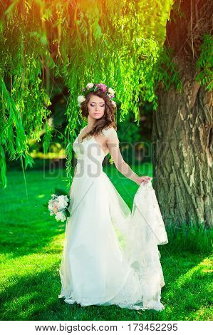 beautiful bride holding a wedding bouquet of flowers and posing