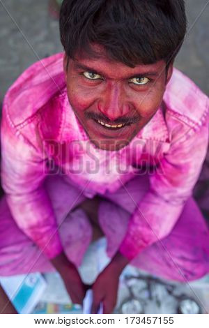Vrindavan, India - March 23: Portrait of an unidentified man with face smeared with colors during Holi celebration in Vrindavan, Uttar Pradesh, India.
