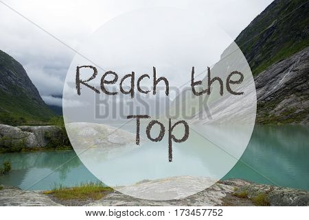 English Text Reach The Top. Lake With Mountains In Norway. Cloudy Sky. Peaceful Scenery, Landscape With Rocks And Grass. Greeting Card