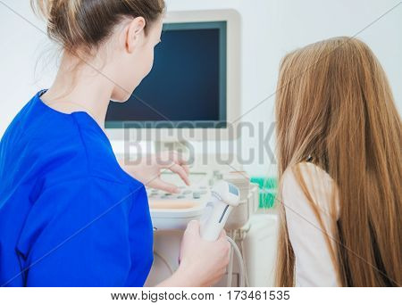 Female Doctor Preparing Little Caucasian Girl For Ultrasonography Imaging. Ultrasonography For Children
