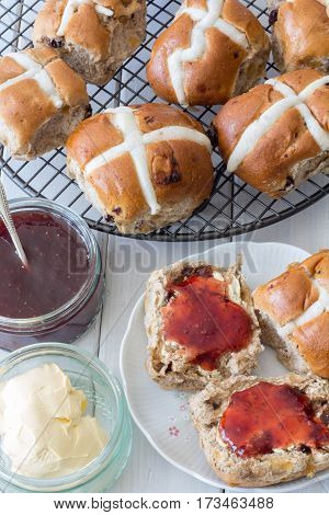 Hot Cross Buns from Above with Jam and Butter Vertical