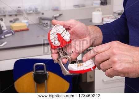Technical shots of model on a dental prothetic laboratory. Dentist hands with model.