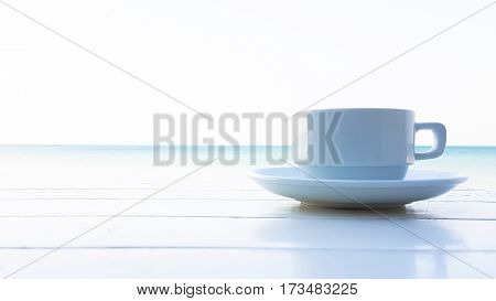 coffee cup on the wooden table with sunflare