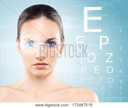 Beautiful woman with laser hologram and test vision table over cyan background.