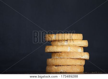 Pile of Dutch beschuits on black dark background