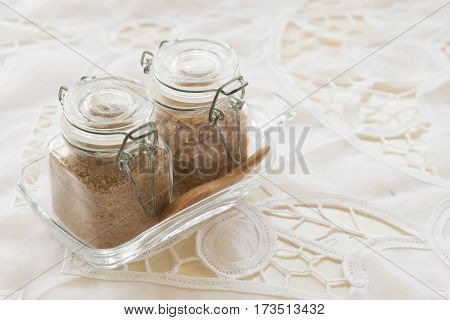 Brown Sugar in glass bottle with wooded spoon on the table in vintage coffe shop