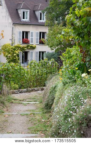 Beautiful house seen from vineyard of Montmartre Paris France.