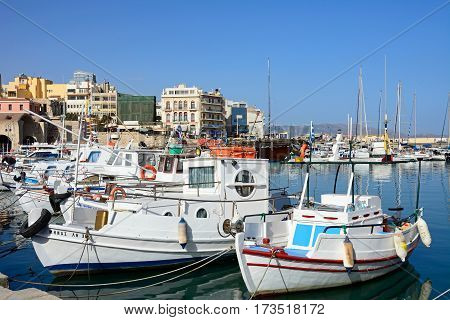 HERAKLION, CRETE - SEPTEMBER 19, 2016 - Yachts and boats moored in the harbour with waterfront buildings to the rear Heraklion Crete Greece Europe, September 19, 2016.
