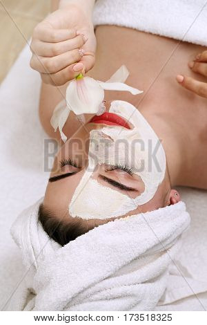 Young beautiful woman with a mask on his face