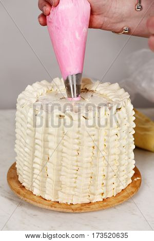 Decorating a cake with flowers of cream