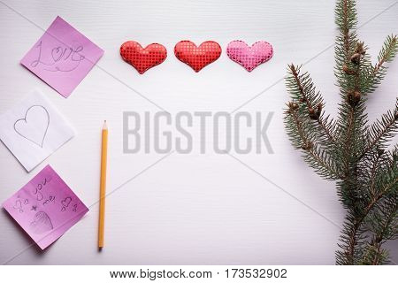 Wooden White Background With A Branch Of Pine And Three Hearts.