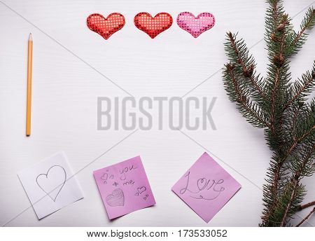 Wooden White Background With A Branch Of Pine And Three Hearts.