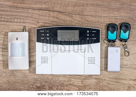 alarm system home on wooden desk .