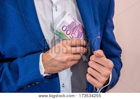 Businessman Removing 500 Euro Banknotes From His Jacket Pocket.