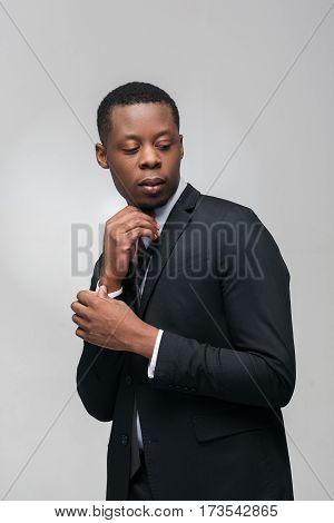 Office worker, businessman. Dress code, style, brand clothes, pricey suit. Portrait of african american man on grey background.