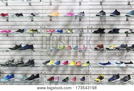 lots of sports sneaker shoes on sale, displayed.