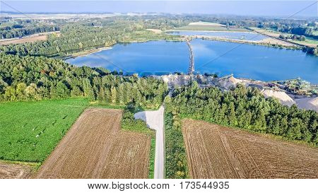 Aerial view of a gravel quarry with beautiful blue lake