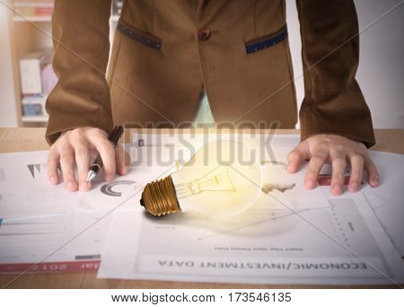 Business worker with light bulb on desk office. concept of new ideas with innovation and creativity.