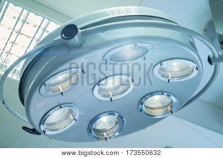 Modern surgical lamp in operating-room of hospital