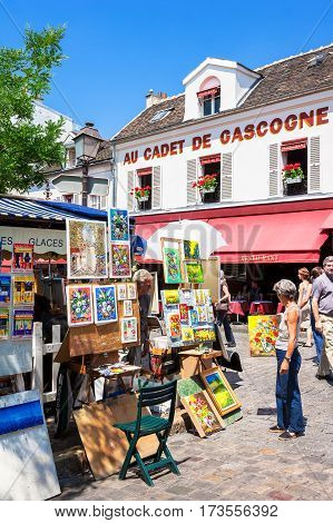 Paris France - June 30 2006: Artists exposing their works to the tourists in open air at Tertre square (Place du Tertre) in Montmartre.