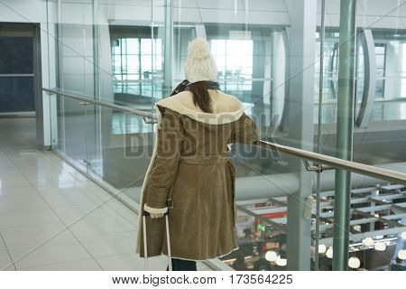 Young woman in airport traveling to a tourist attraction