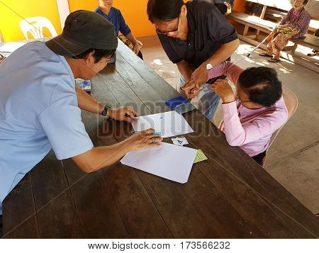 CHIANG RAI THAILAND - DECEMBER 19 : Unidentified asian old woman fingerprinting on paper before treatment on December 19 2016 in Chiang rai Thailand.