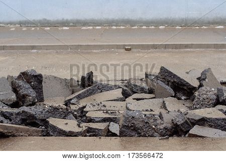 Broken asphalt on the street made for digging trenches for laying of communications in the city