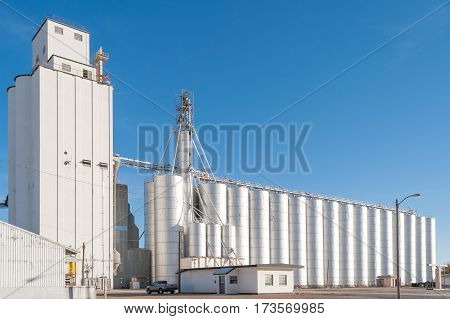 Tower and silos of big grain elevator in rural Texas, USA