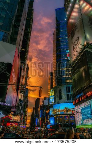 NEW YORK CITY, USA - AUGUST 14, 2016: Buildings and street life on the Times Square - one of the world's most visited tourist attractions, drawing an estimated 50 million visitors annually. Lowlight.