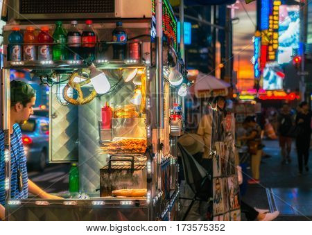 NEW YORK CITY, USA - AUGUST 14, 2016: Buildings and street life on the Times Square - one of the world's most visited tourist attractions, drawing an estimated 50 million visitors annually. Lowlight.