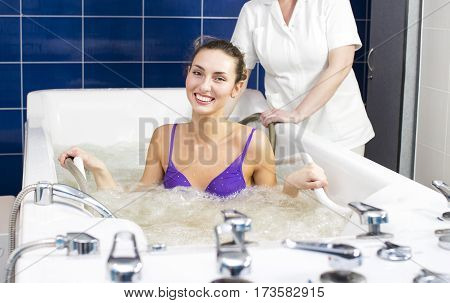 Young woman during hydromassage in beauty salon