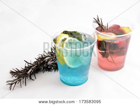 two fresh drink with lemon, mint and rosemary on a white background