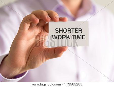 Businessman Holding A Card With Shorter Work Time Message