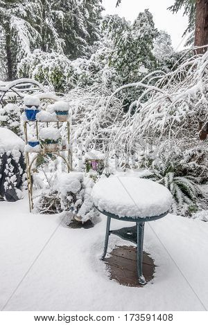 A porch is covered in white fluffy snow after a storm.