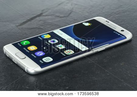 Koszalin, Poland - February 27, 2016: Photo of Samsung Galaxy S7 Edge white pearl. Samsung 7 Edge are new generation smartphone from Samsung. The Samsung S7 Edge is smart phone with multi touch screen