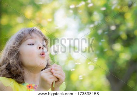 Happy Child Blowing Dandelion Flower Outdoors