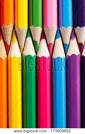 Row of the vertical Color pencils close up. Pencil tips combined opposite each other. School and education. Drawing and painting.