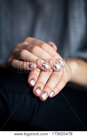 Stylish gray manicure with overflowing Fashion hands fingers