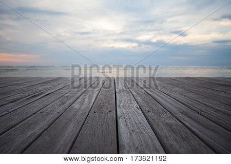 Closeup of old wooden floors and a tropical beach at sunset