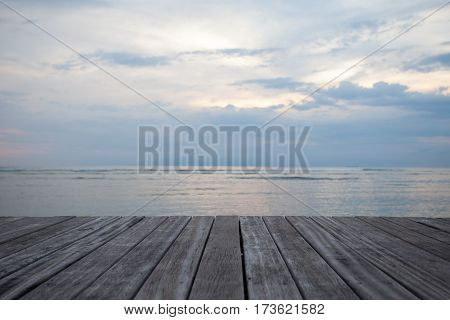 Closeup of old wooden floors and a tropical beach at sunset