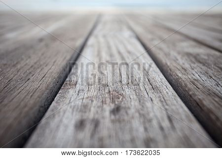 Closeup of old wooden floors and a tropical beach at sunset