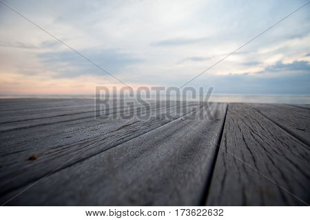 Closeup of old wooden floors and a tropical beach at sunset