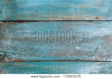 Vintage wood background with peeling blue paint.