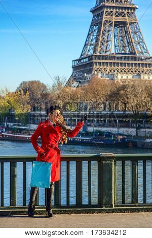 Woman On Embankment Near Eiffel Tower In Paris Handwaving