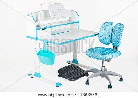 Blue chair school table blue basket desk lamp and black support under legs on the white isolated background.