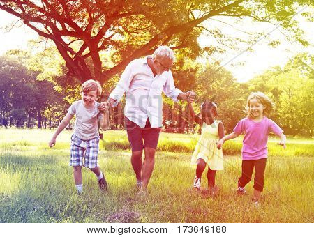 Grandfather Enjoy Grandchildren Outdoors Together