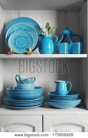Wooden shelves with blue rustic dinnerware