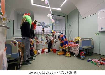 ST. PETERSBURG, RUSSIA - FEBRUARY 16, 2017: Doctor in clown costume examines the child in the St. Magdalena children's hospital. The hospital was founded in 1829