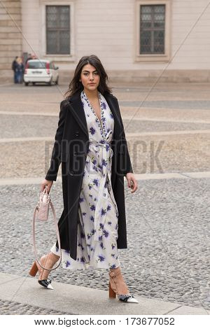 MILAN ITALY - FEBRUARY 23: Fashionable woman poses outside Genny fashion show during Milan Women's Fashion Week on FEBRUARY 23 2017 in Milan.